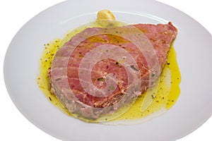 Slice of tuna on plate close up