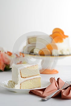 Slice of vanilla cake on plate with napkin