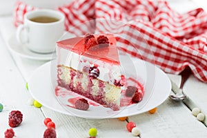 Slice of vanilla sponge cake with yogurt souffle and raspberry j