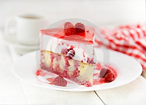 Slice of vanilla sponge cake with yogurt souffle and raspberry j