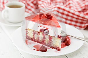 Slice of vanilla sponge cake with yogurt souffle and raspberry j