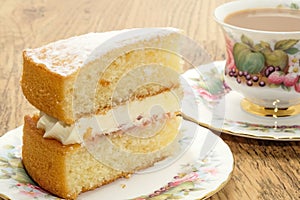 Slice of Victoria sponge cake with a hot drink