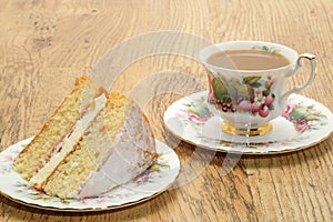 Slice of Victoria sponge cake with a hot drink