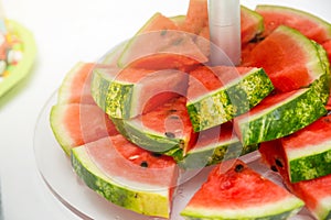 Slice of watermelon on the white plate close up