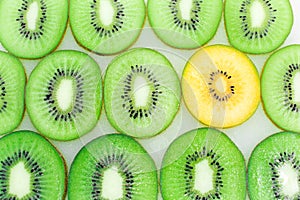 Slice of Yellow Kiwi Among Green Kiwi