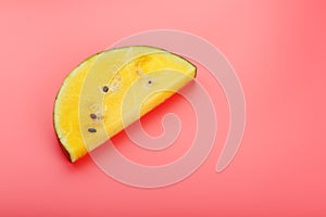 Slice of Yellow watermelon on a pink background. Bright summer background