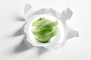 Sliced apple and hole in paper