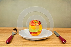 Sliced apple and orange on plate. Healthy diet concept