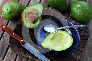Sliced avocado on old wooden chopping board