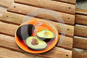 Sliced avocado on orange plate