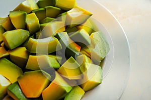 Sliced avocado is served on a ready-made white plate