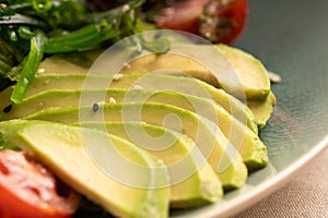 sliced avocado with vegetables for healthy breakfast or snack.
