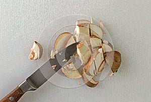 Sliced baby bella mushrooms with a knife