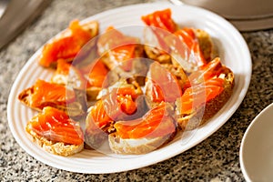 Sliced baguette with butter and smoked salmon fillet
