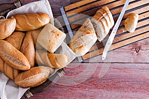 Sliced baguette and rolls on a buffet table