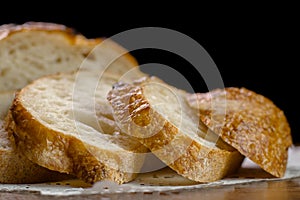 Sliced baked wheat bread on napkin on table selective focus