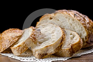 Sliced baked wheat bread on napkin on table selective focus