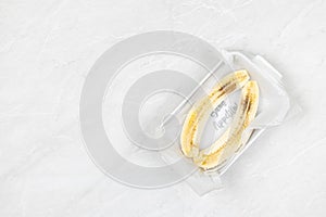 Sliced Banana in the bowl above grey marble table