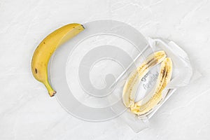 Sliced Banana in the bowl above grey marble table