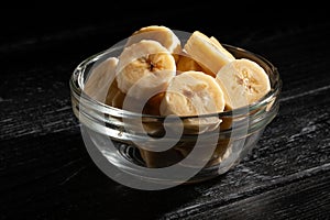 sliced banana bowl on black wood