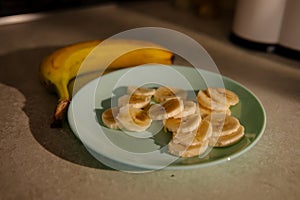 Sliced banana in bowl. Kitchen background. Selective focus
