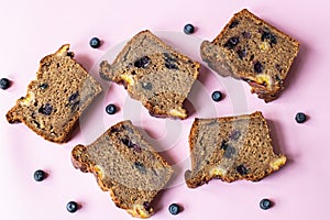 Sliced banana bread with blueberries on yellow background