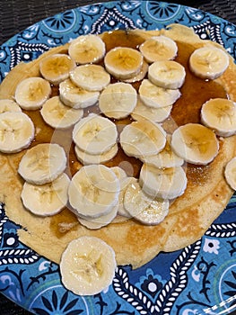 Sliced banana on a pancake with syrup