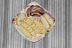 sliced bananas, apples and whole banana on a plate healthy nutrient breakfast menu