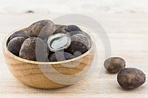 Sliced Barometer Earthstars mushroom in the wood bowl on wood ba