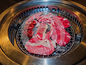 Sliced beef on hot charcoal grill