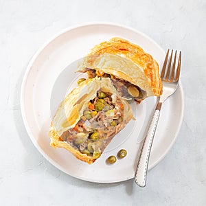 Sliced beef pot pie on plate, top view, square