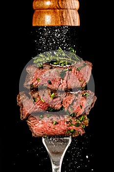 Sliced beef steak from grill on a fork photo