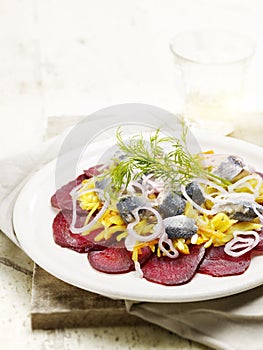 Sliced beetroot served with herring