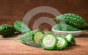 Sliced bitter gourd on a rustic wooden background