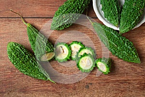 Sliced bitter gourd on a rustic wooden background