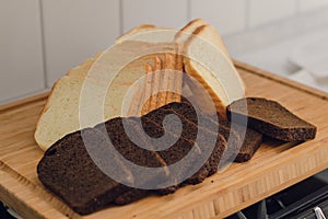 sliced black rye and white bread on a cutting board on the plate.