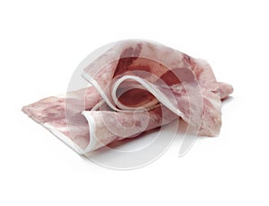 Sliced blade of sausage of wild boar meat on a white table and background photo
