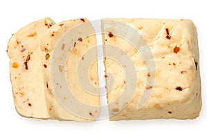 Sliced block of halloumi cheese with red chilli isolated on white from above