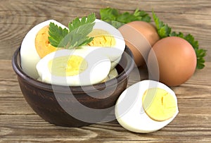 Sliced boiled eggs, with parsley leaves. Cooking a salad with boiled eggs