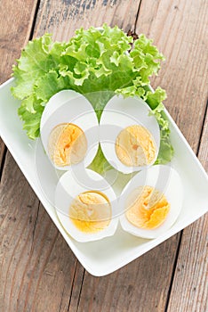 Sliced boiled eggs on white plate. Top view.