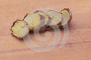 Sliced boiled potato on wooden cutting board