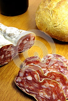 Sliced boloney, bread and wine