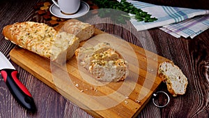 Sliced bread baguette with cheese on top on a  board