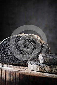 Sliced bread of black color on a wooden table