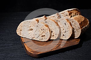 Sliced bread on cutting board. Slices of grain bread
