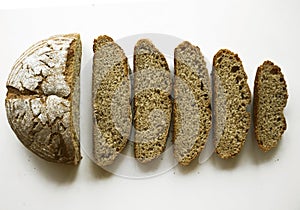 Sliced bread isolated on a white background. Bread slices and crumbs around viewed from above. Top view. Slices of rye bread