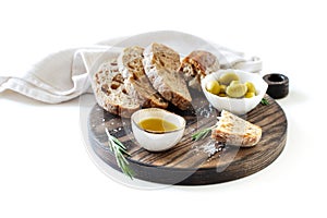 Sliced bread, olives and olive oil