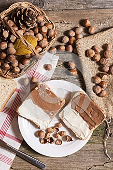 Sliced bread in plate with chocolate cream and nuts