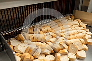 Sliced bread on the production line of food and bakery products. One of the stages of the production of croutons. Bread