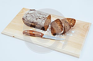 Sliced bread slices and knife on a wooden table